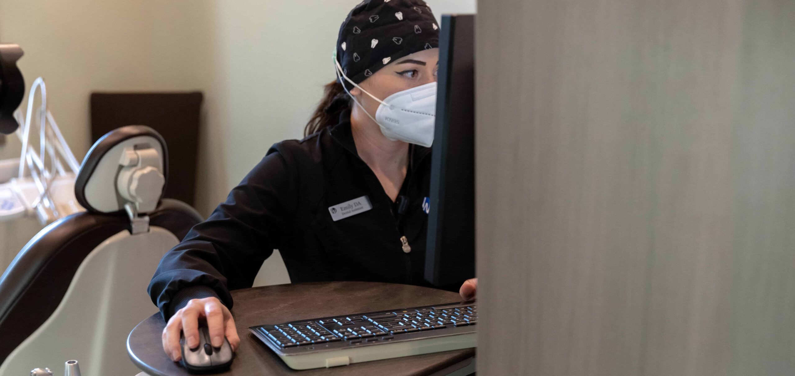 A member of the West Wind Dental Team at the computer.