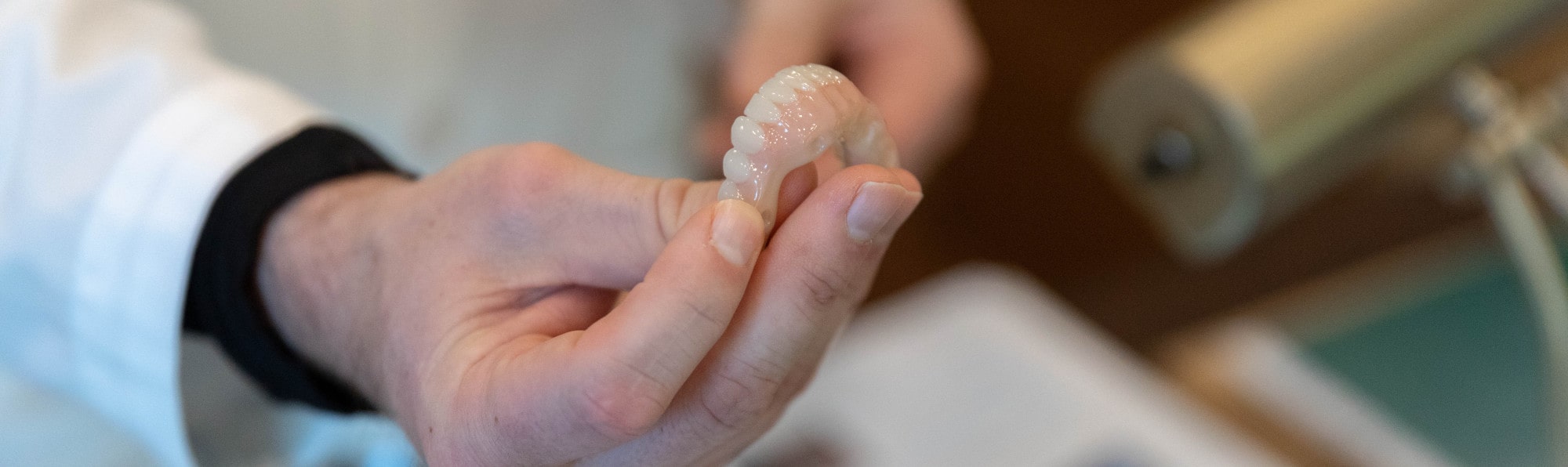 A dentist holding whole mouth dental implants.